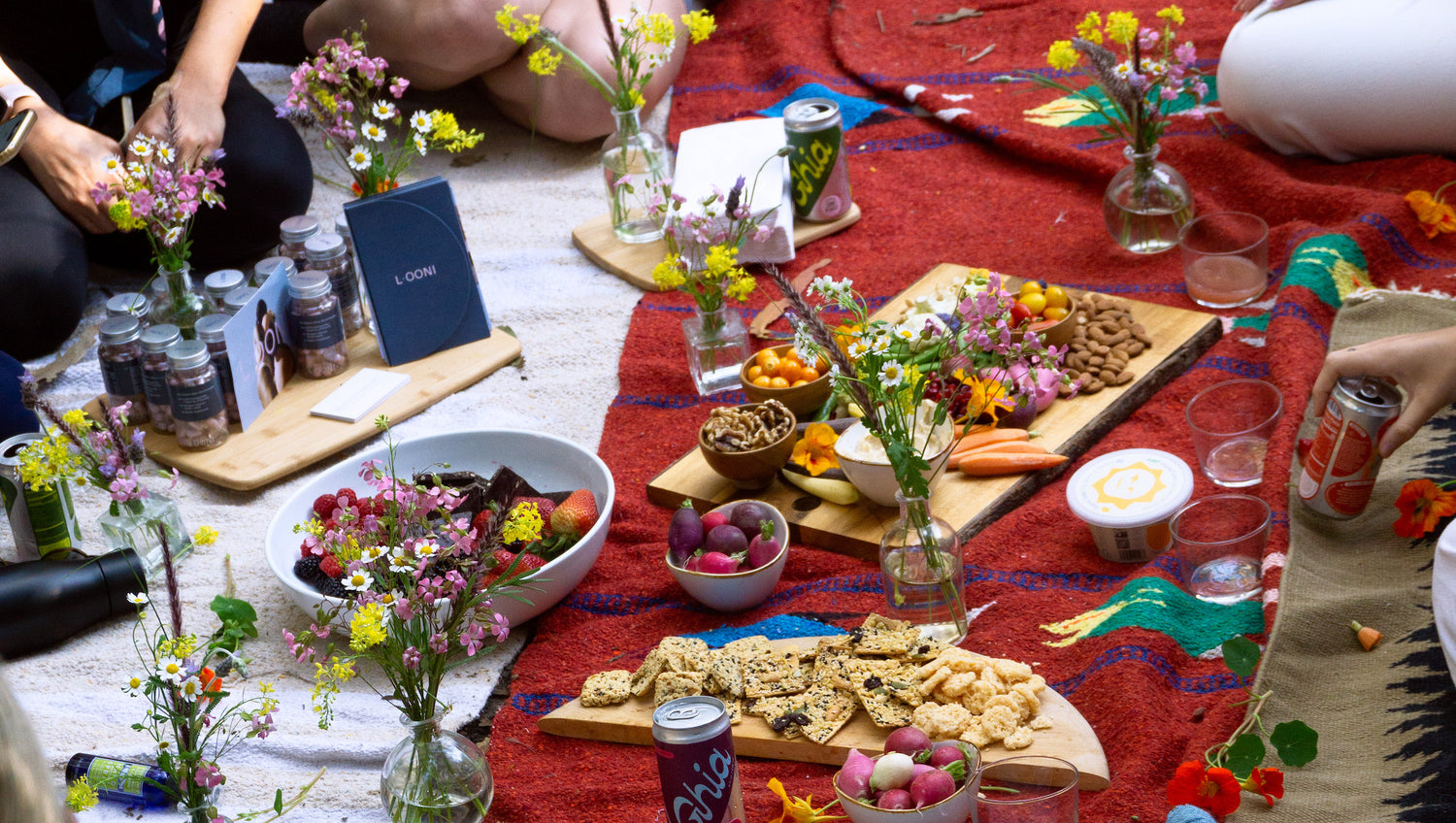 Looni blog post on their strawberry moon forage walk with photo of a picnic and flowers